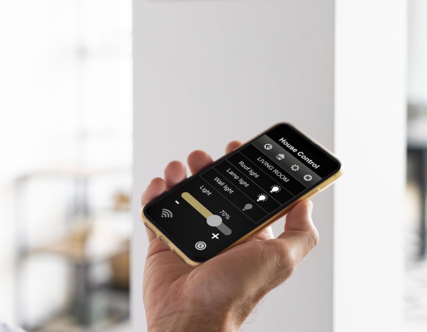 person-using-smartphone-his-automated-home (1)
